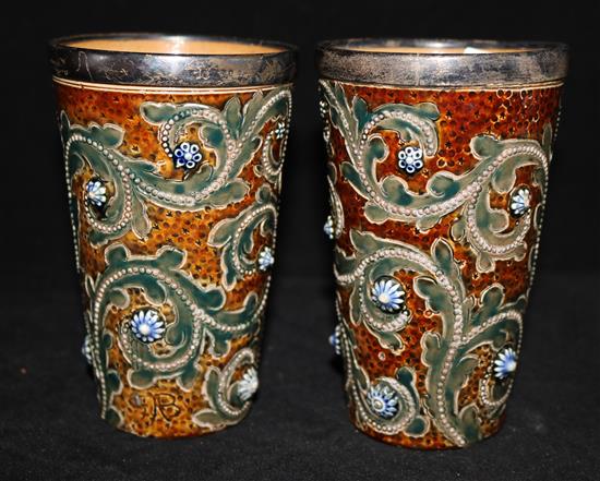 A pair of Doulton silver rim beakers